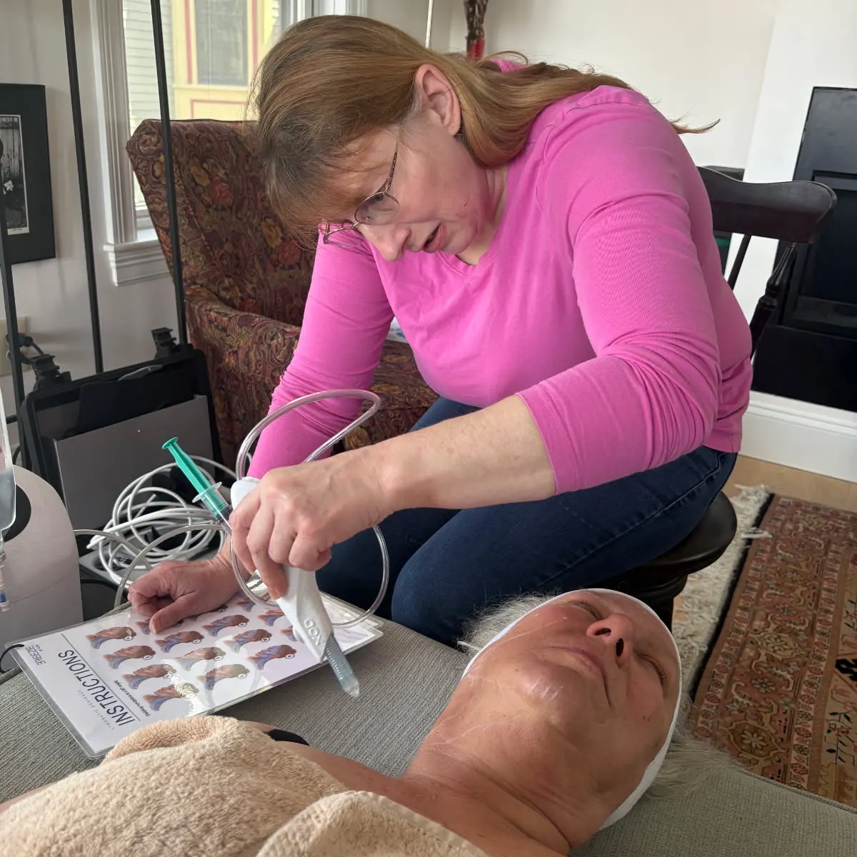 Client receiving a Breeze facial treatment at home